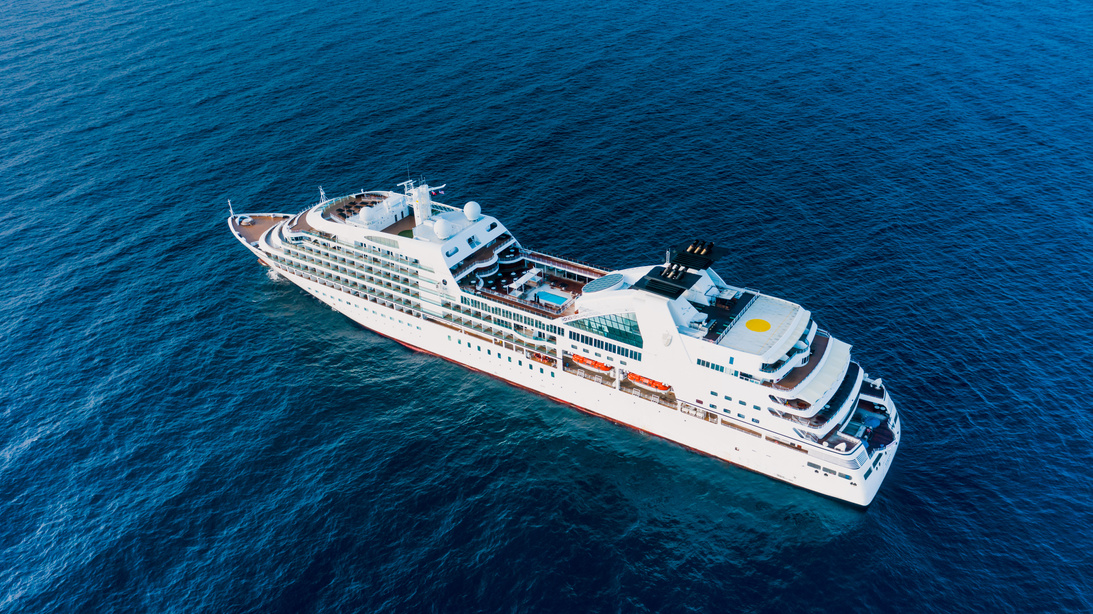 Cruise ship floating on blue sea in sunny day